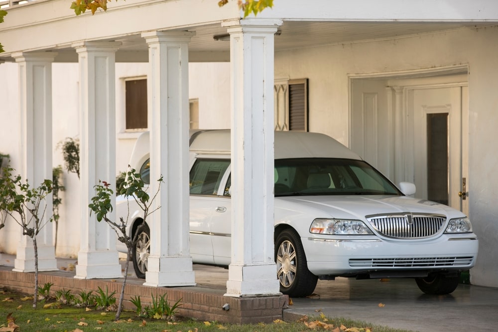 White hearse outside of funeral home