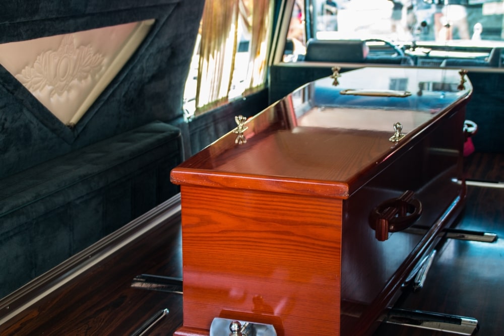 Wooden casket in funeral home hearse